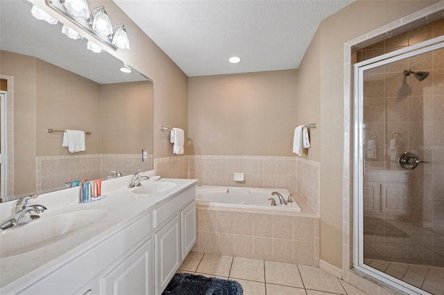 bathroom featuring a textured ceiling, plus walk in shower, tile patterned flooring, and double sink vanity