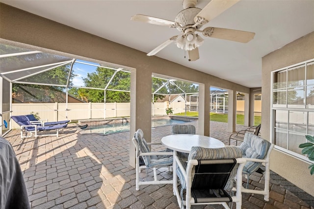 sunroom / solarium featuring ceiling fan