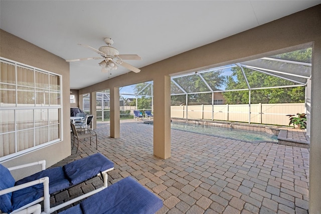 unfurnished sunroom featuring ceiling fan