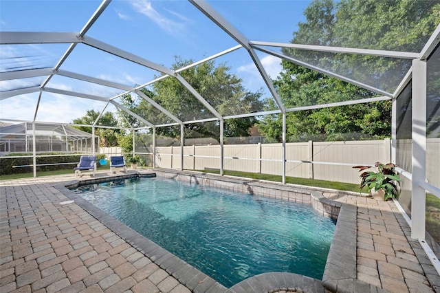 view of pool with a lanai and a patio