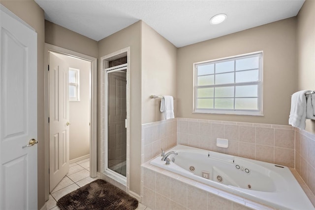 bathroom featuring shower with separate bathtub, tile patterned floors, and a textured ceiling