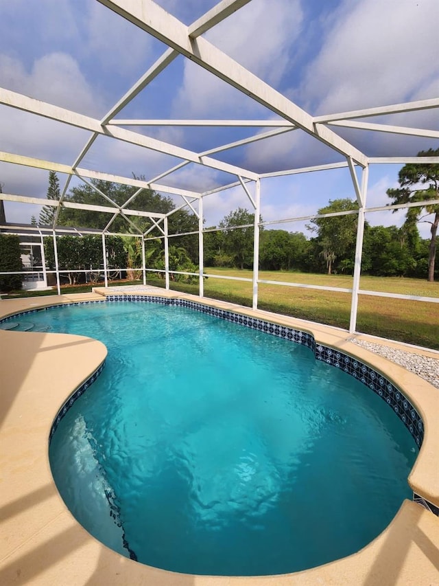 view of pool with a patio, a lanai, and a yard