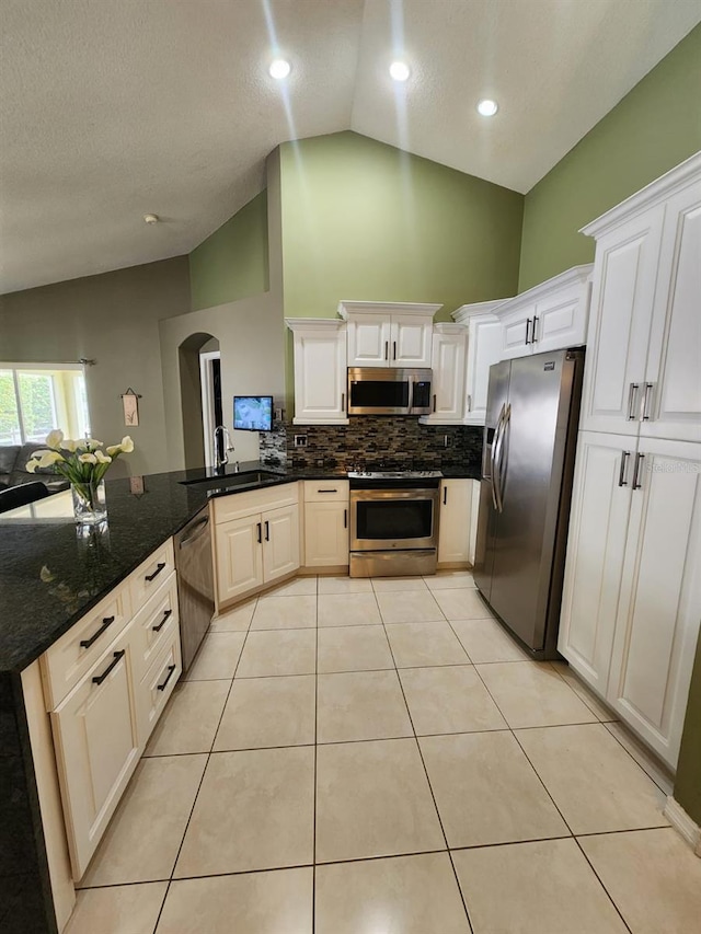 kitchen featuring kitchen peninsula, white cabinetry, stainless steel appliances, and sink