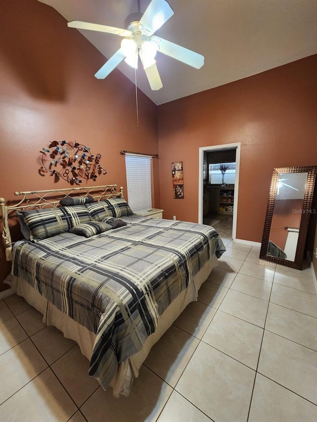 bedroom featuring light tile patterned floors, vaulted ceiling, and ceiling fan