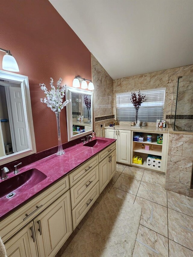 bathroom featuring vanity, tile walls, and vaulted ceiling