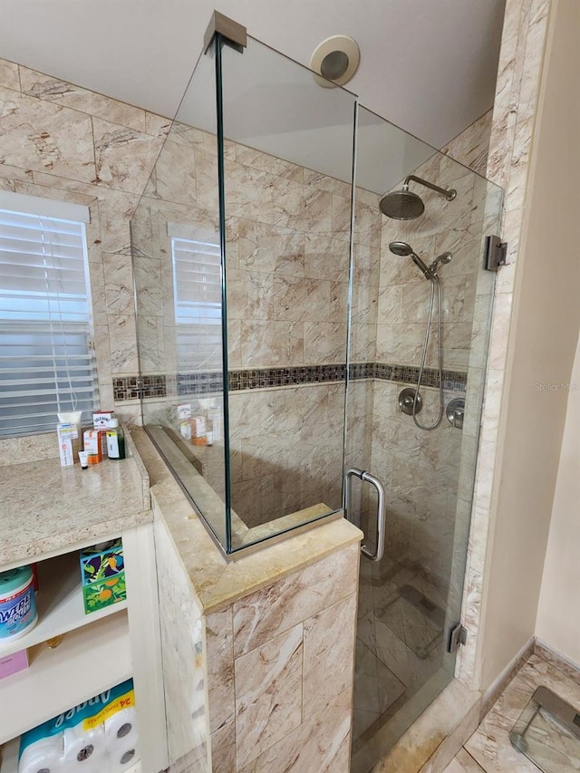 bathroom featuring a shower with door