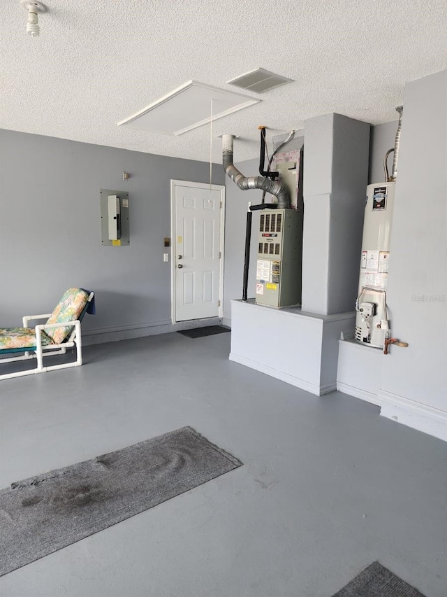 garage featuring water heater, electric panel, and heating unit