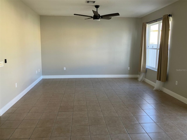 unfurnished room with ceiling fan and tile floors