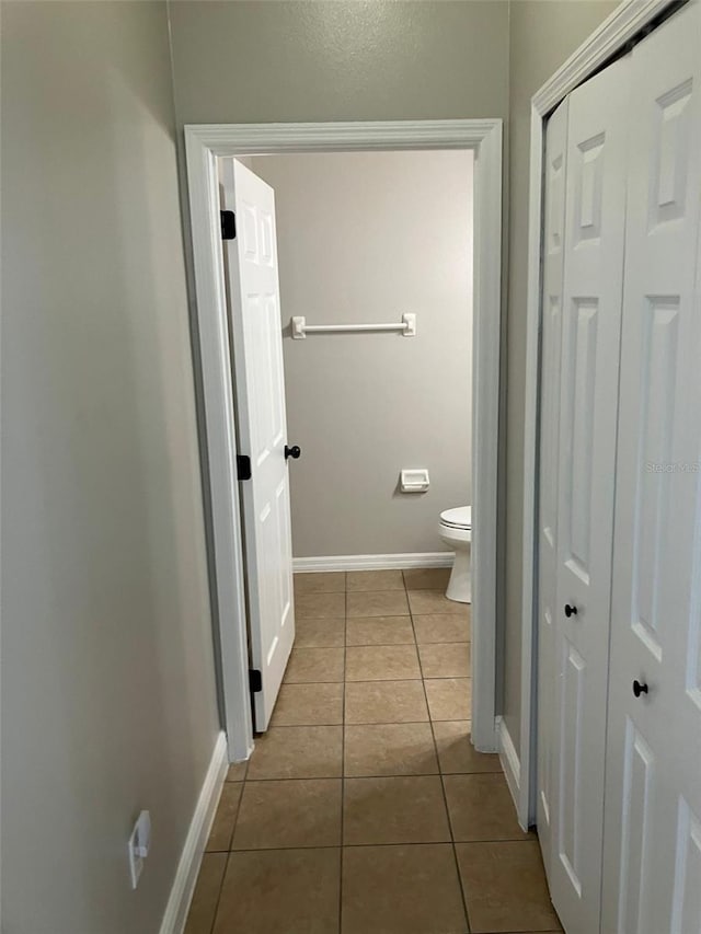 bathroom with tile floors and toilet