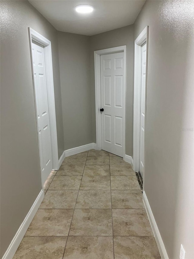 hall with light tile flooring