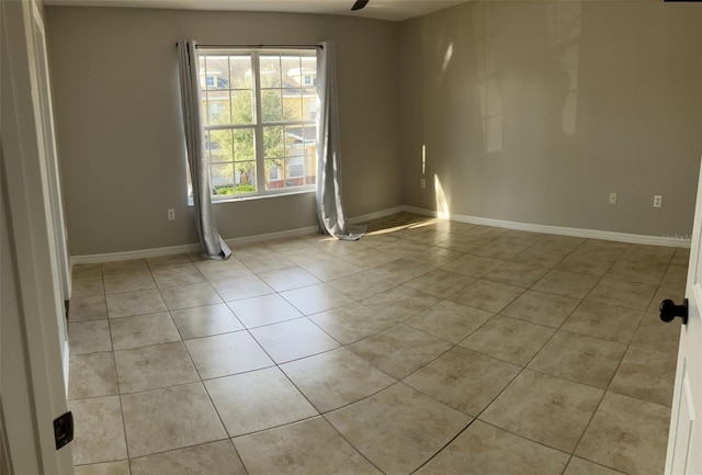 unfurnished room featuring light tile flooring