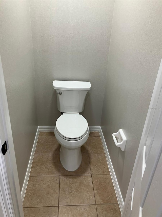 bathroom featuring tile floors and toilet