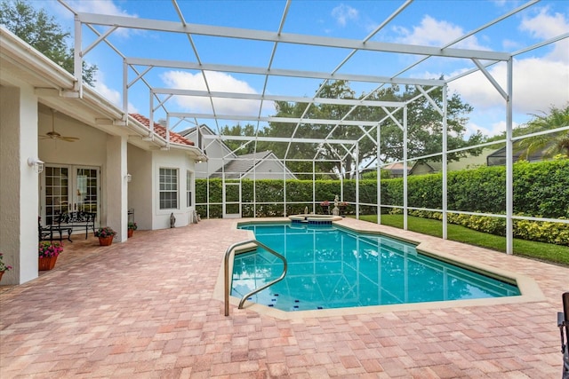 view of pool with an in ground hot tub, ceiling fan, a patio, and a lanai