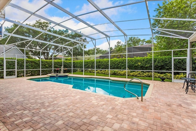 view of swimming pool featuring a patio and a lanai