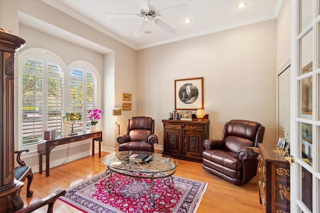 sitting room featuring ornamental molding, light hardwood / wood-style flooring, and ceiling fan