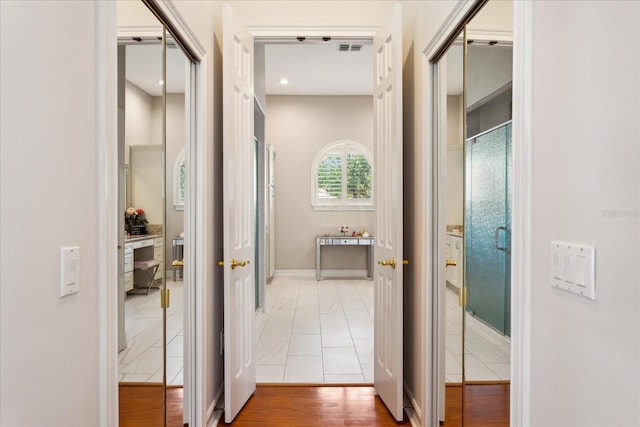 corridor with wood-type flooring