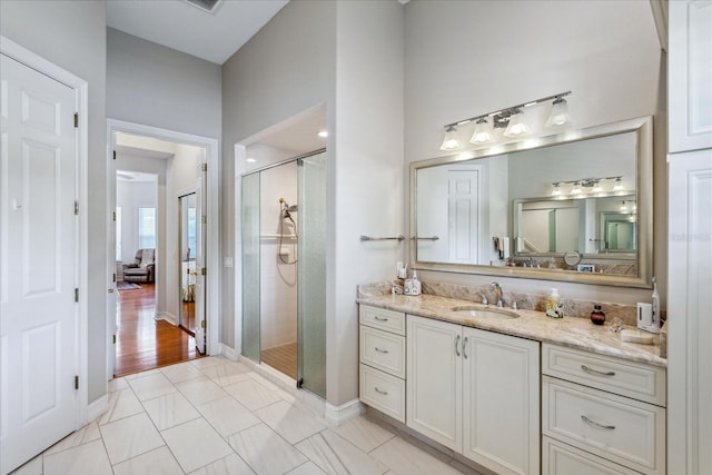 bathroom featuring vanity, walk in shower, and wood-type flooring