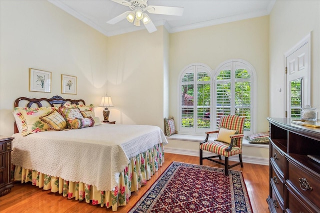 bedroom featuring ornamental molding, hardwood / wood-style flooring, and ceiling fan