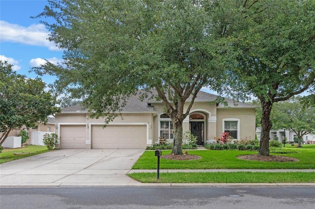 view of front of home with a garage and a front yard