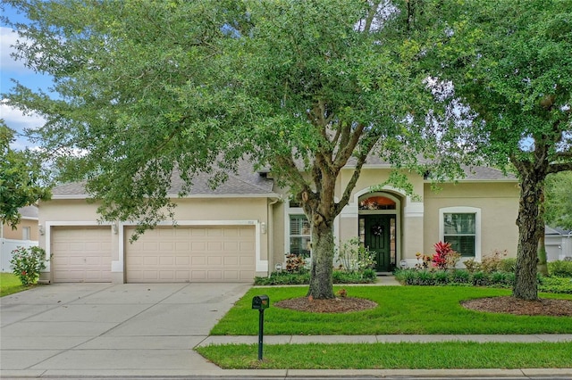 view of front facade featuring a garage and a front lawn