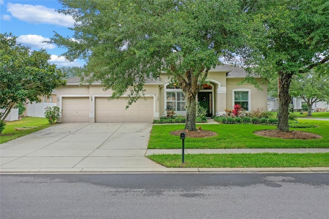 view of front of house featuring a garage and a front yard