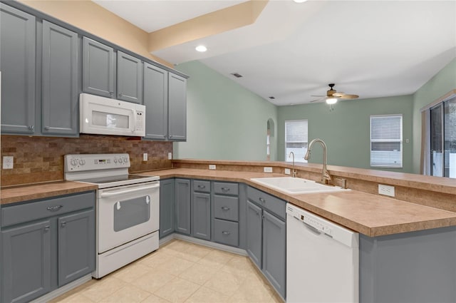 kitchen featuring white appliances, gray cabinets, and sink