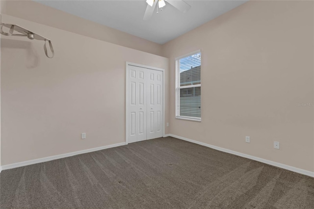 empty room with ceiling fan and carpet