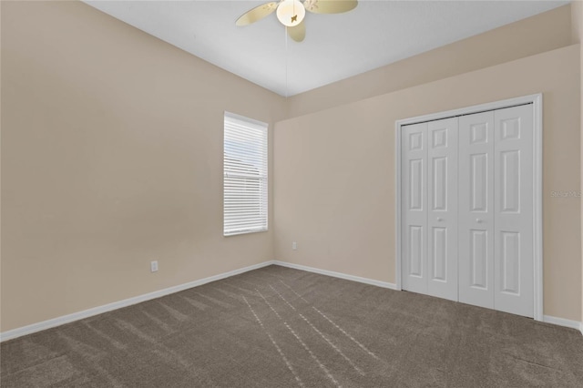 unfurnished bedroom featuring carpet flooring, ceiling fan, and a closet