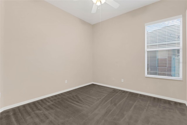 carpeted spare room with ceiling fan