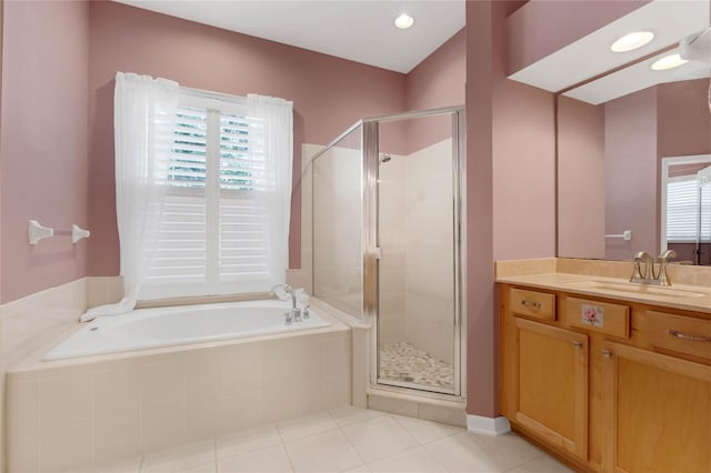 bathroom with tile patterned flooring, vanity, separate shower and tub, and a healthy amount of sunlight