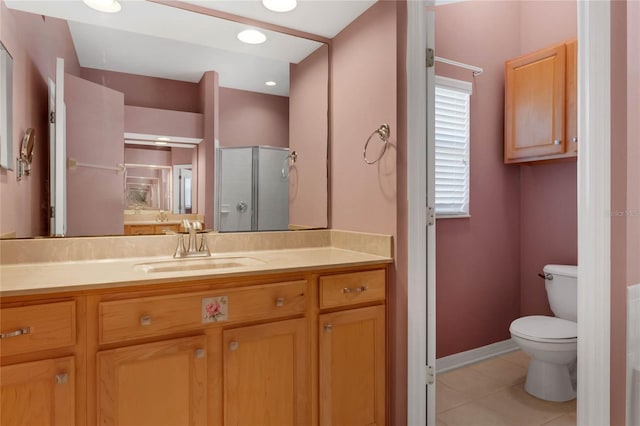 bathroom with vanity, tile patterned flooring, a shower with shower door, and toilet