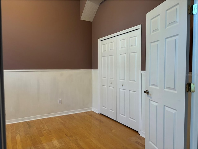 unfurnished bedroom with light hardwood / wood-style flooring and a closet