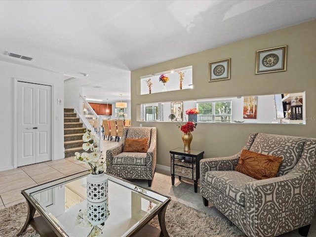 living room featuring tile floors and a textured ceiling