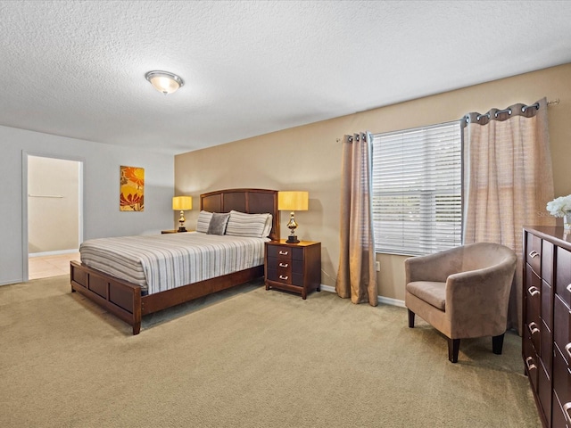 bedroom with a textured ceiling and carpet