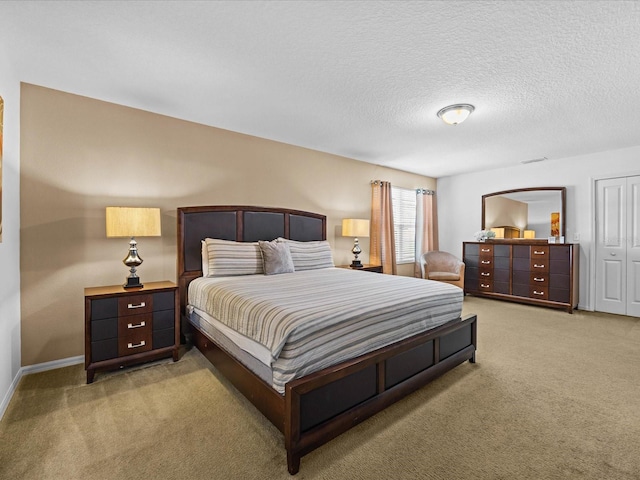 bedroom with a textured ceiling and carpet