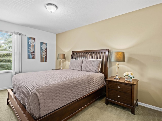 carpeted bedroom featuring a textured ceiling