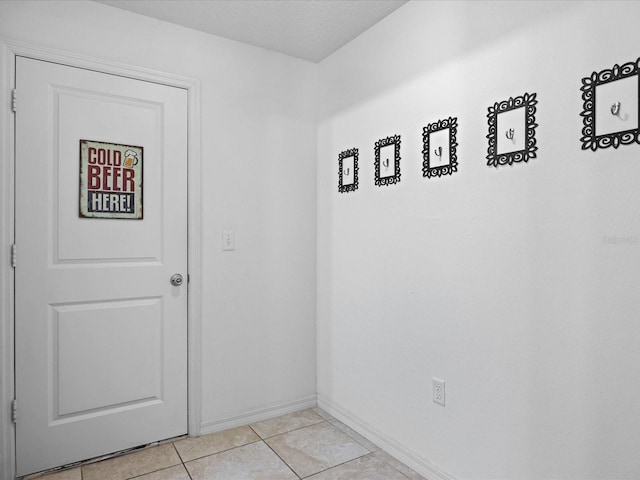 corridor featuring light tile flooring