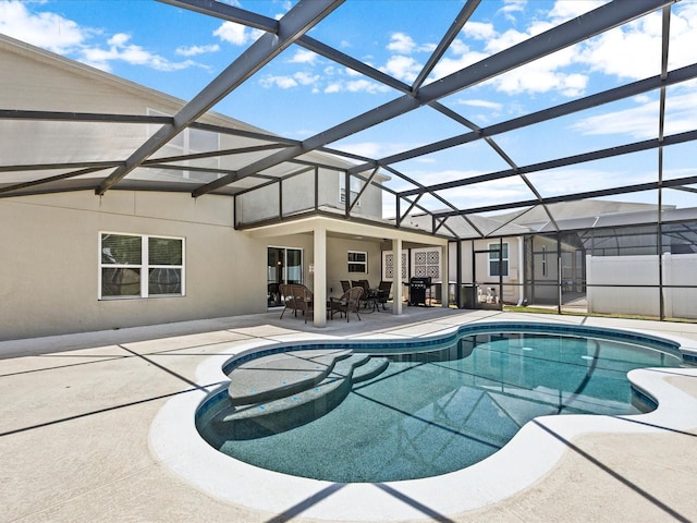 view of pool with a patio and glass enclosure