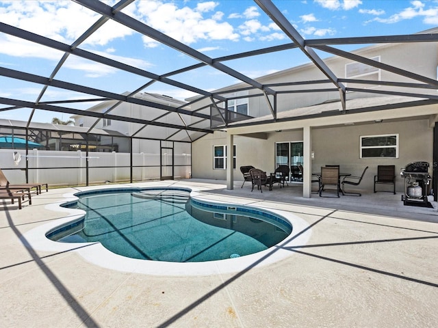 view of swimming pool with glass enclosure and a patio area