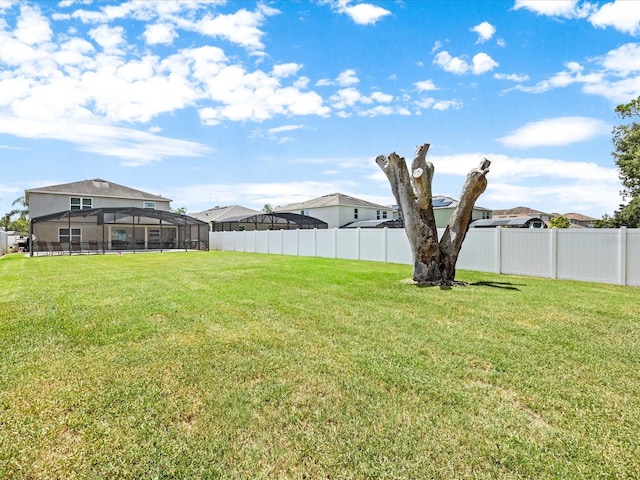 view of yard featuring glass enclosure