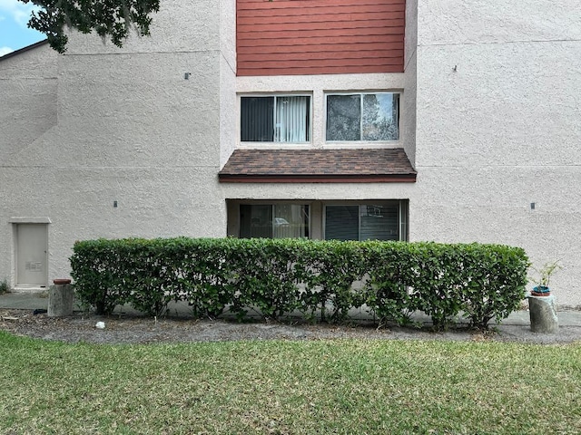 view of property exterior with a yard