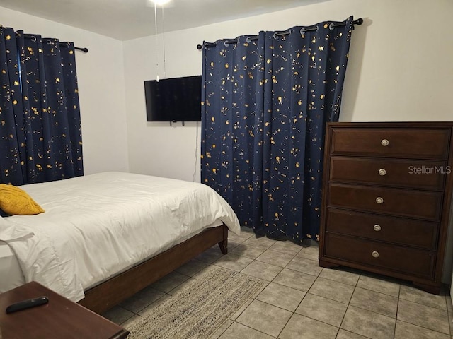 bedroom featuring light tile floors