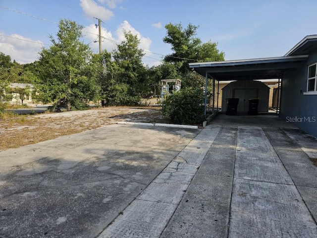 exterior space featuring a shed and a carport