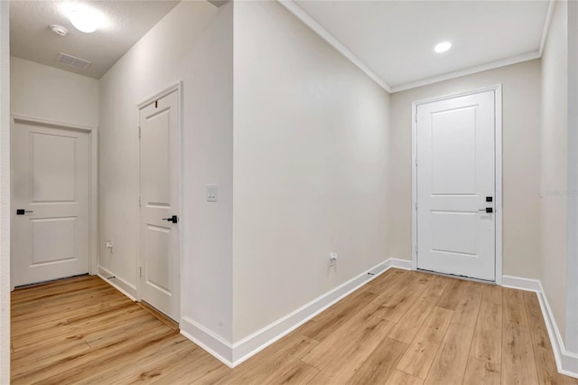 hall featuring ornamental molding and light wood-type flooring