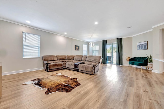 living room featuring light hardwood / wood-style flooring and crown molding