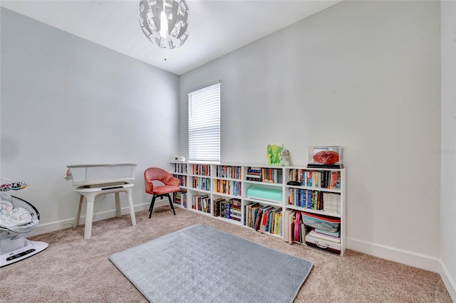 game room with an inviting chandelier and carpet flooring