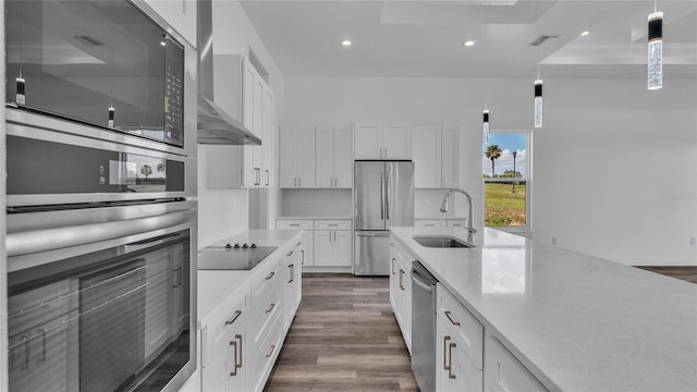 kitchen featuring black appliances, hanging light fixtures, dark hardwood / wood-style flooring, white cabinets, and sink