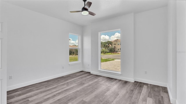 empty room with hardwood / wood-style flooring and ceiling fan