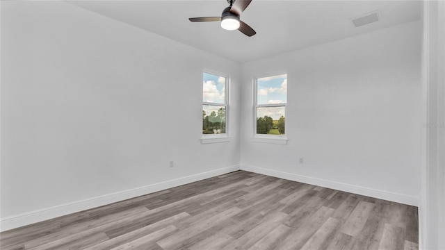 unfurnished room featuring ceiling fan and hardwood / wood-style floors