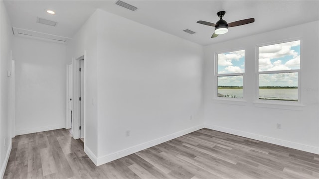 spare room with ceiling fan and light hardwood / wood-style floors